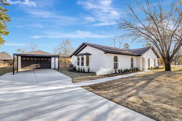 a large kitchen with granite countertop a large counter top stainless steel appliances and cabinets