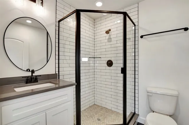 a bathroom with a toilet a sink and a mirror