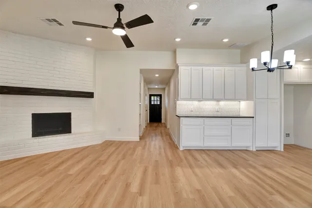 a view of a kitchen with a sink cabinets and wooden floor