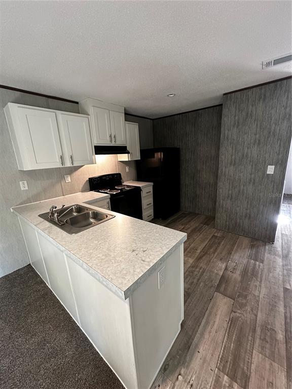 3060 Southeast 48th Street Ocala, FL 34480 - Photo 6 of 10 a kitchen with a sink a stove a refrigerator and cabinets