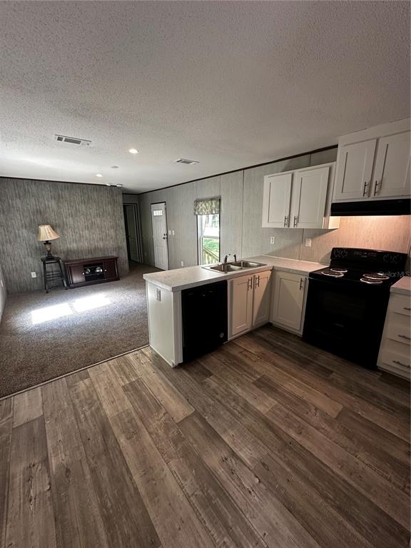 3060 Southeast 48th Street Ocala, FL 34480 - Photo 7 of 10 a large kitchen with wooden floors and stainless steel appliances