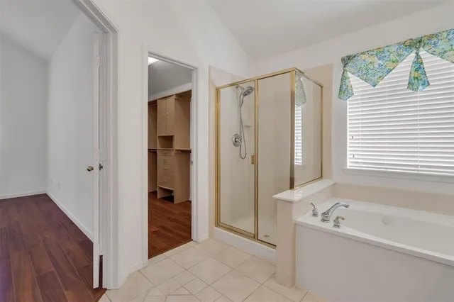 a bathroom with a bathtub and a shower