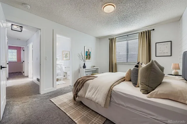 a bedroom with a bed and a couch