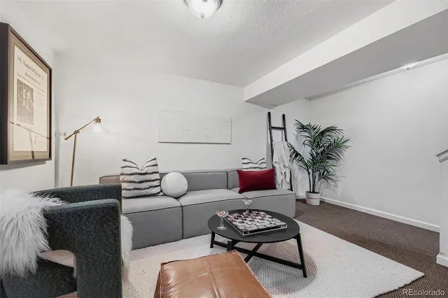a living room with furniture rug and wooden floor