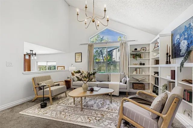 a living room with furniture and a chandelier