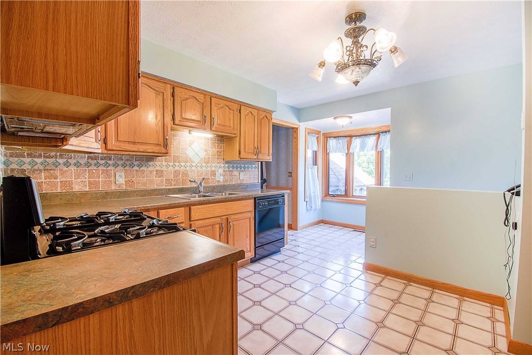 1272 Stewart Road Salem, OH 44460 - Photo 12 of 30 The kitchen offer appliances, plenty of cabinet storage, tile backsplash, tile floor, and a charming breakfast nook (6x8) with a bay window that overlooks the backyard.