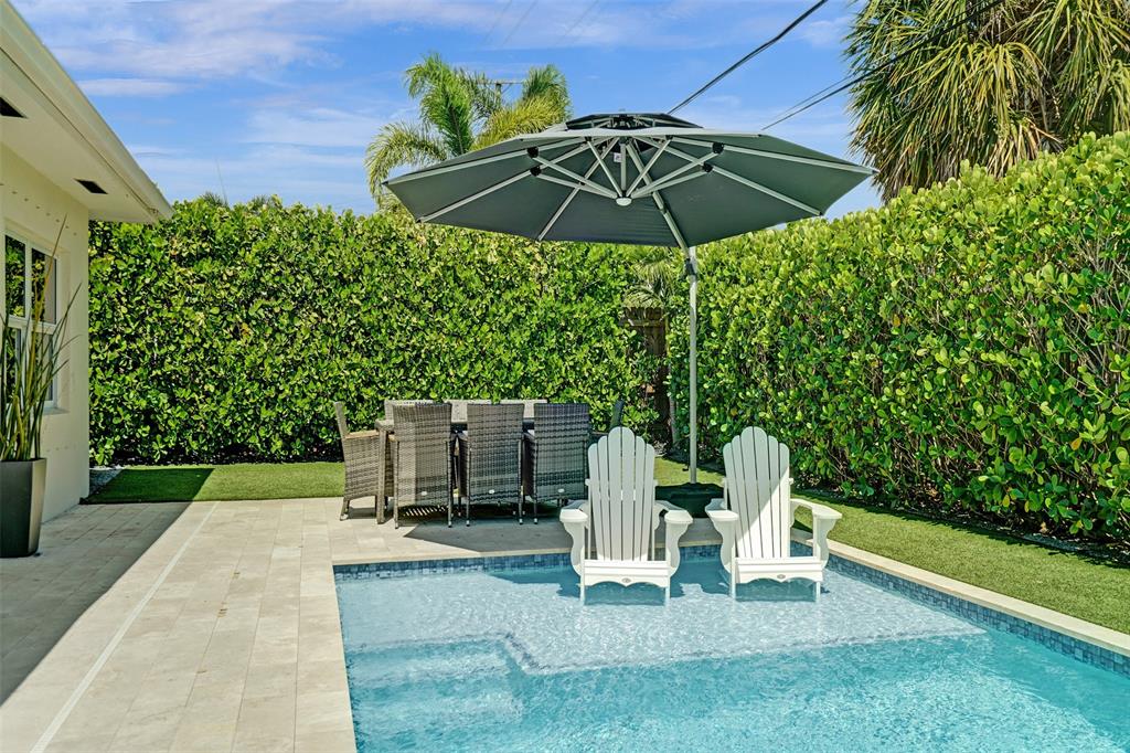 2185 Northeast 61st Court Fort Lauderdale, FL 33308 - Photo 14 of 49 a view of a chair and fire pit in the garden