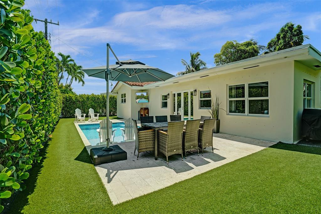 2185 Northeast 61st Court Fort Lauderdale, FL 33308 - Photo 15 of 49 a view of a patio with table and chairs potted plants with wooden fence