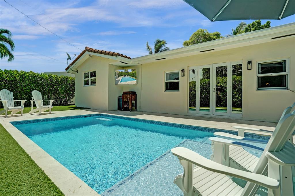2185 Northeast 61st Court Fort Lauderdale, FL 33308 - Photo 16 of 49 a view of house with swimming pool yard and outdoor seating