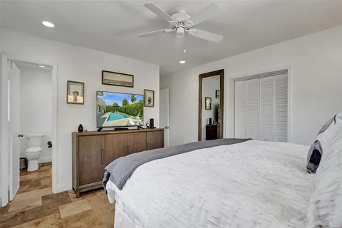 a room with a bed and a dresser