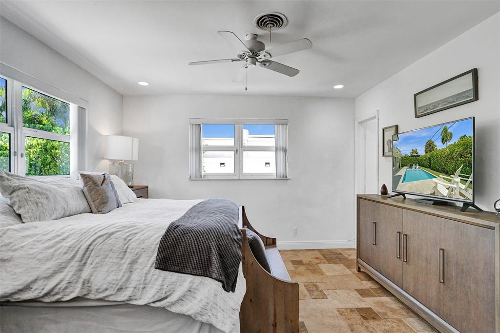 2185 Northeast 61st Court Fort Lauderdale, FL 33308 - Photo 20 of 49 a bedroom with a bed and a flat screen tv