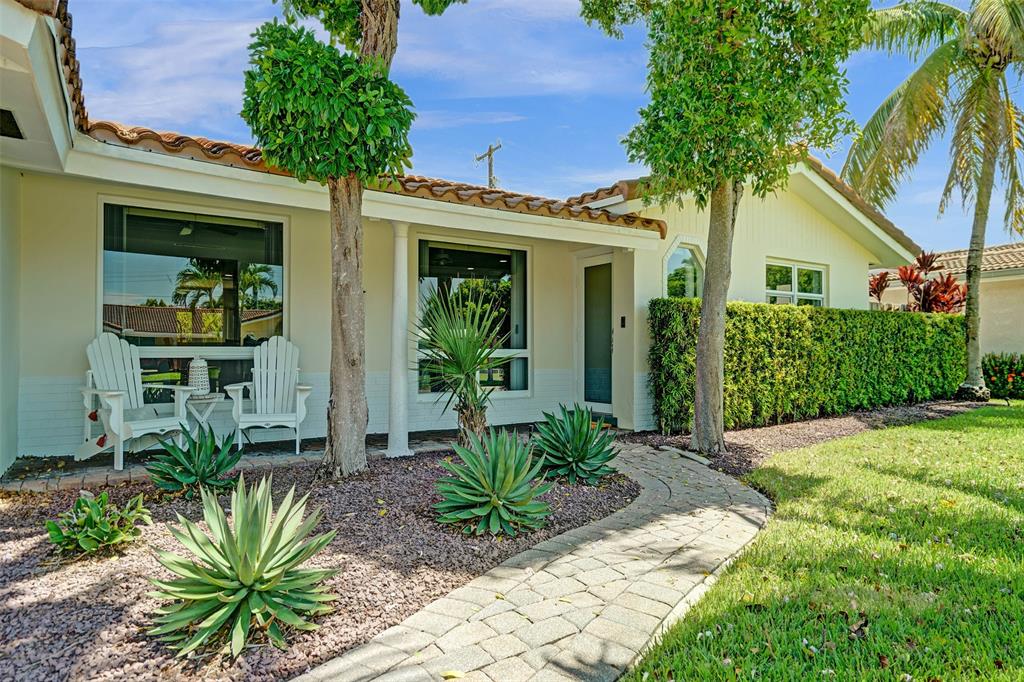 2185 Northeast 61st Court Fort Lauderdale, FL 33308 - Photo 2 of 49 a front view of a house with a porch