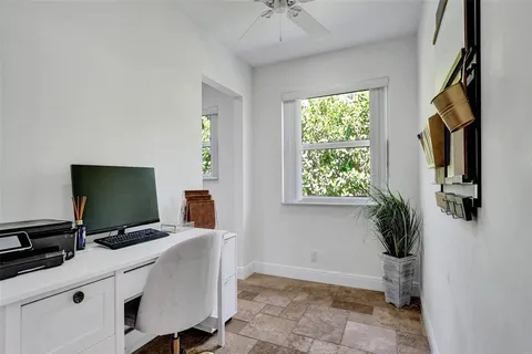 a view of a workspace with furniture and flat screen tv
