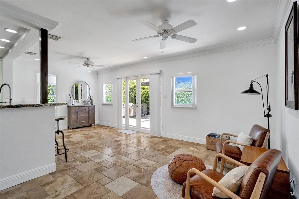 2185 Northeast 61st Court Fort Lauderdale, FL 33308 - Photo 30 of 49 a living room with furniture a chandelier and a rug