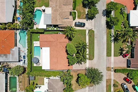 an aerial view of a house with a yard and garden