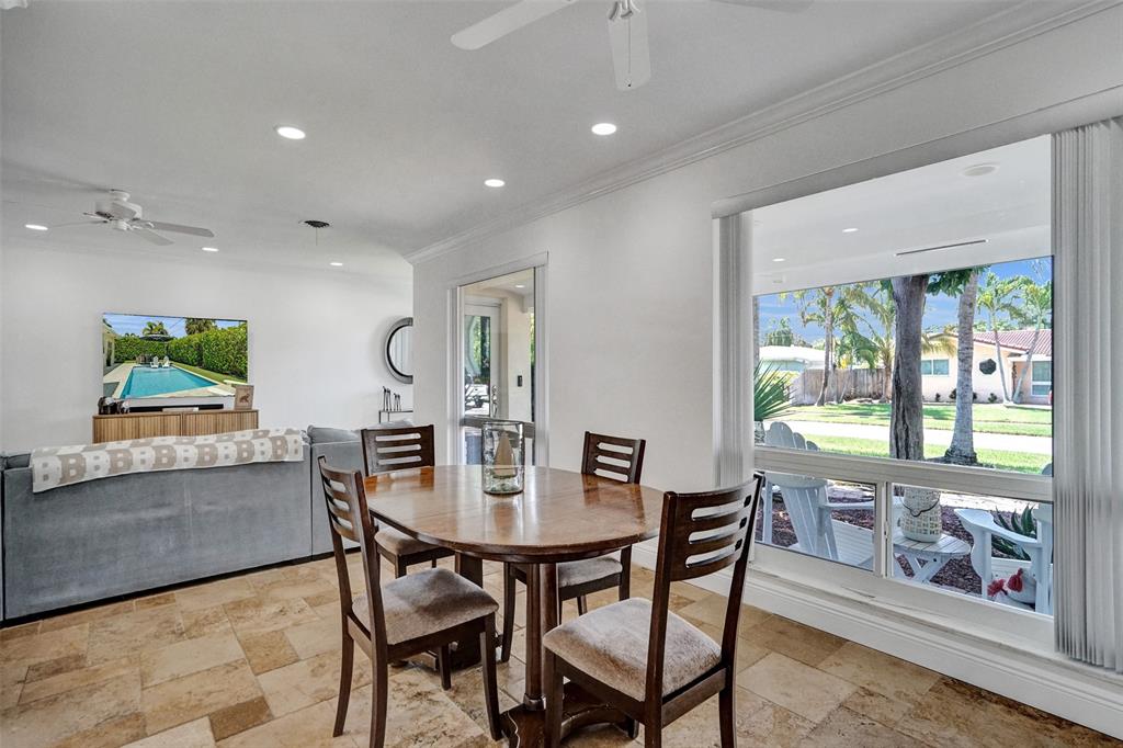2185 Northeast 61st Court Fort Lauderdale, FL 33308 - Photo 32 of 49 a dining room with furniture a rug and a floor to ceiling window