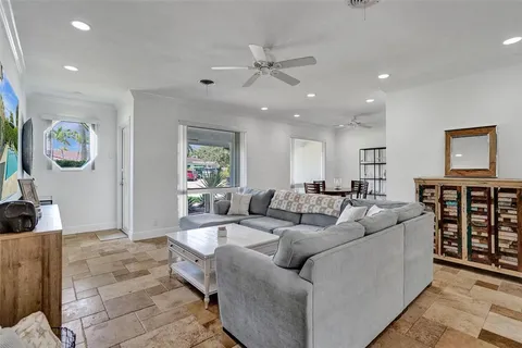 a living room with furniture and ceiling fan