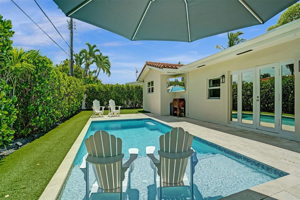 2185 Northeast 61st Court Fort Lauderdale, FL 33308 - Photo 42 of 49 a patio with swimming pool table and chairs