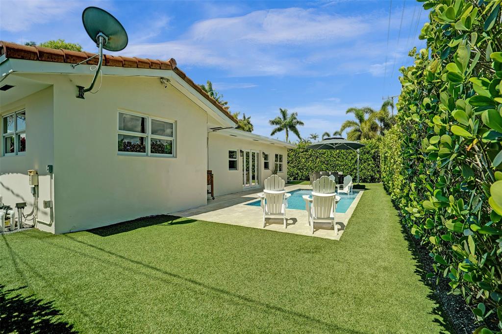 2185 Northeast 61st Court Fort Lauderdale, FL 33308 - Photo 43 of 49 a front view of a house with garden