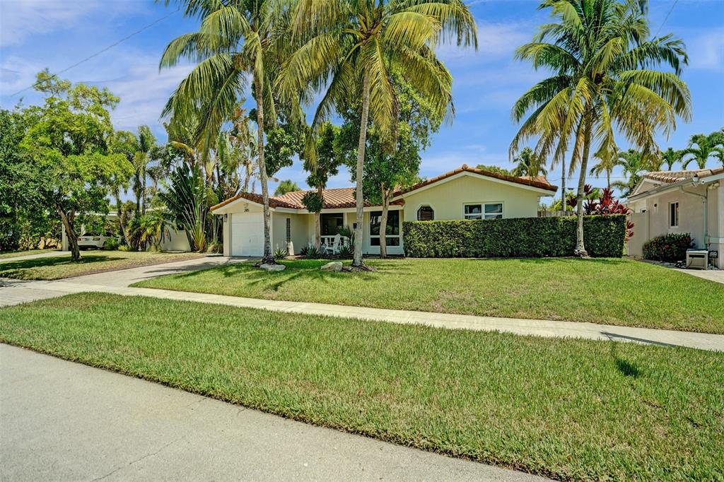 2185 Northeast 61st Court Fort Lauderdale, FL 33308 - Photo 44 of 49 a view of a house with a big yard and palm trees