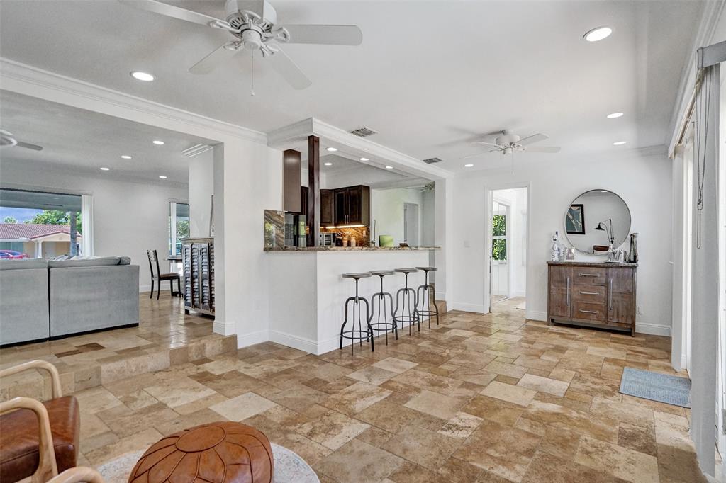 2185 Northeast 61st Court Fort Lauderdale, FL 33308 - Photo 8 of 49 a view of a kitchen with furniture and a living room