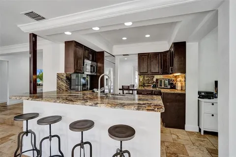 a kitchen with kitchen island a appliances a counter space and a sink
