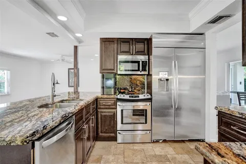 a kitchen with a stove and a refrigerator