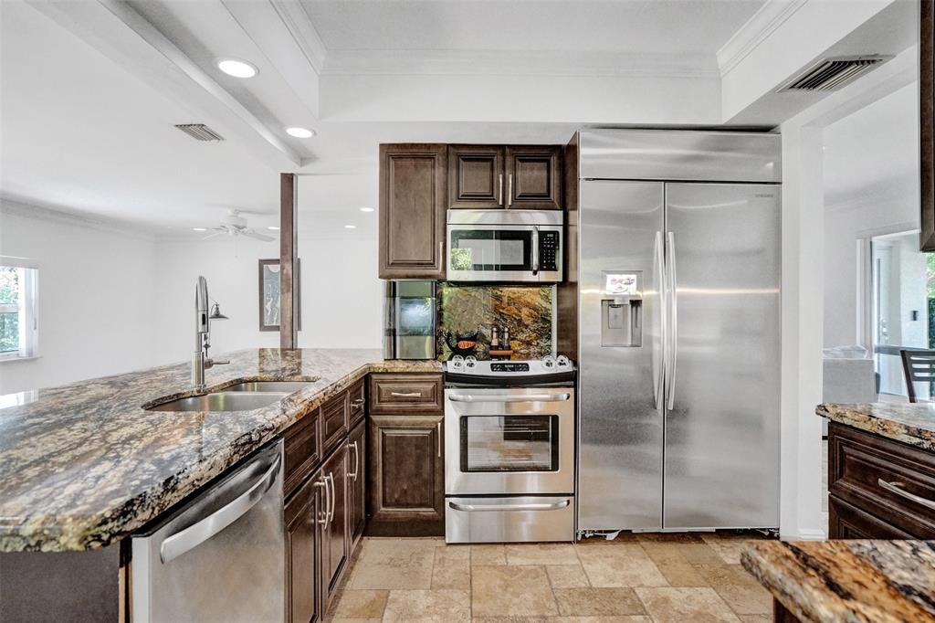 2185 Northeast 61st Court Fort Lauderdale, FL 33308 - Photo 10 of 49 a kitchen with a stove and a refrigerator