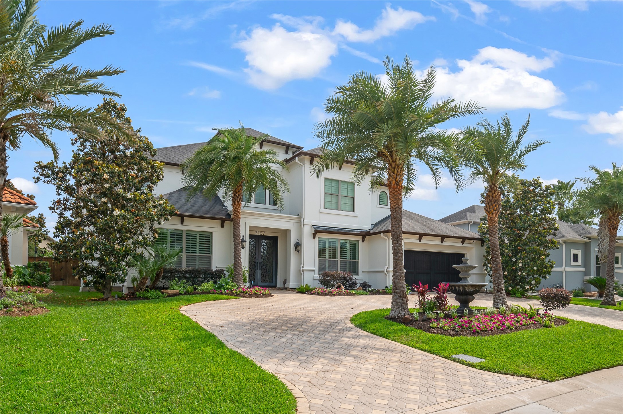 2127 Thicket Ridge Lane Houston, TX 77077 - Photo 2 of 48 Professional landscaping and a full yard 12-zone irrigation Rachio system that can be controlled via your phone greatly enhance this residence.
