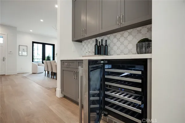 a kitchen with granite countertop a sink a stove and cabinets