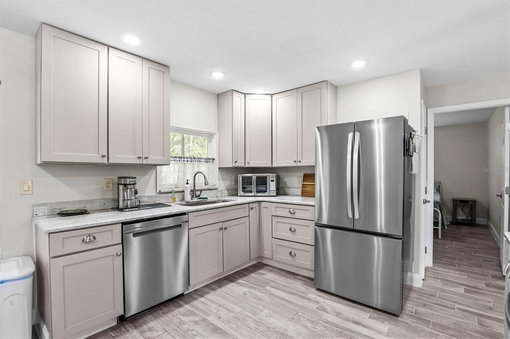 6244 Colony Circle Weeki Wachee, FL 34607 - Photo 42 of 60 a kitchen with stainless steel appliances granite countertop a refrigerator sink and cabinets