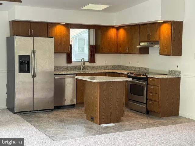 a kitchen with a sink stove and refrigerator
