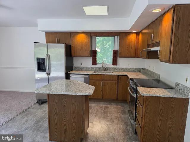 a kitchen with a sink a stove and cabinets