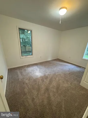 an empty room with a ceiling fan
