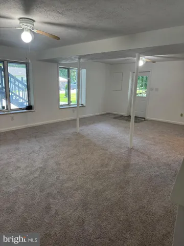 an empty room with windows and entrance