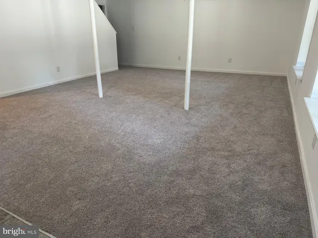 a utility room with granite countertop cabinets