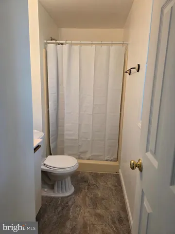 a white toilet sitting next to a bathroom sink