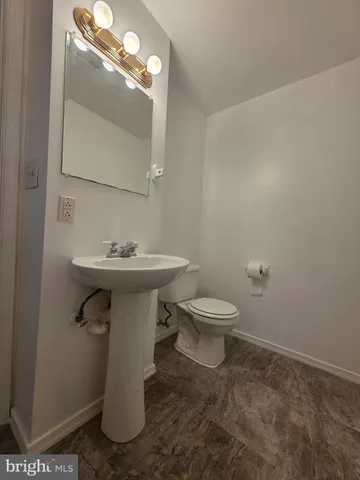 an empty room with closet and a chandelier fan