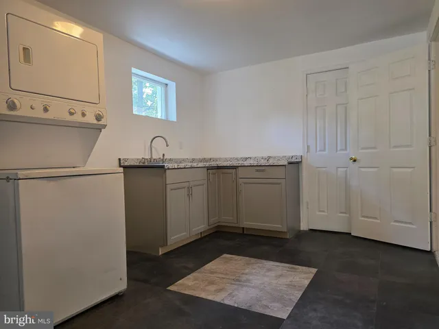 an empty room with closet and windows