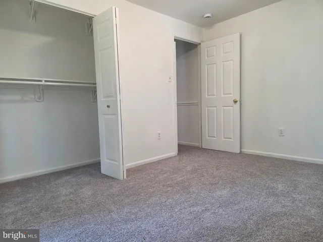 an empty room with closet area