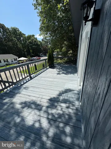 a view of balcony with wooden floor and fence