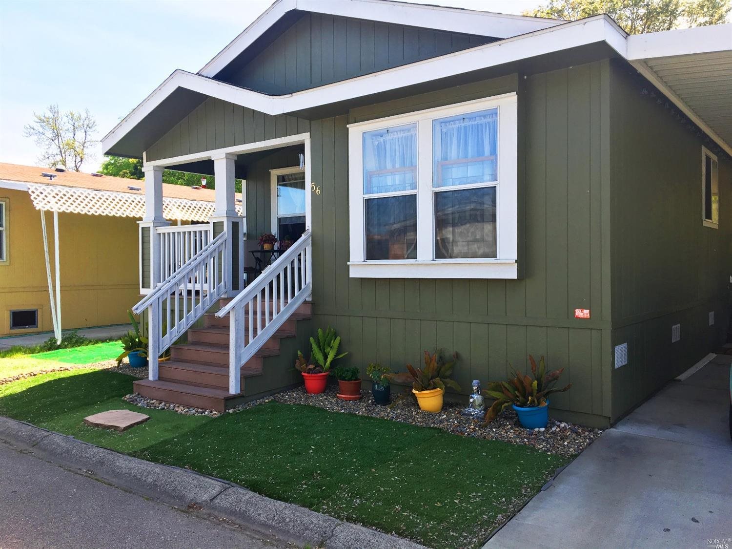 56 Yosemite Road, Unit 56 San Rafael, CA 94903 - Photo 1 of 1 a view of a house with a yard porch and wooden fence