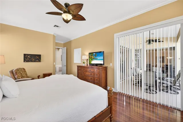 a bedroom with a bed and a mirror on dresser