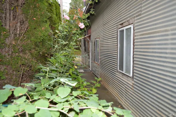 a view of backyard with seating area and green space