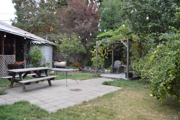 a view of a chair and table in backyard