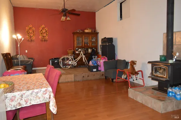 a living room with furniture fireplace and large windows