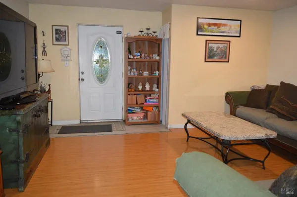 a living room with furniture and next to a window