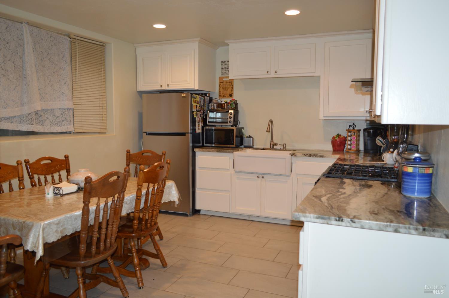 230 Shell Lane Willits, CA 95490 - Photo 30 of 32 a kitchen with a dining table chairs and refrigerator
