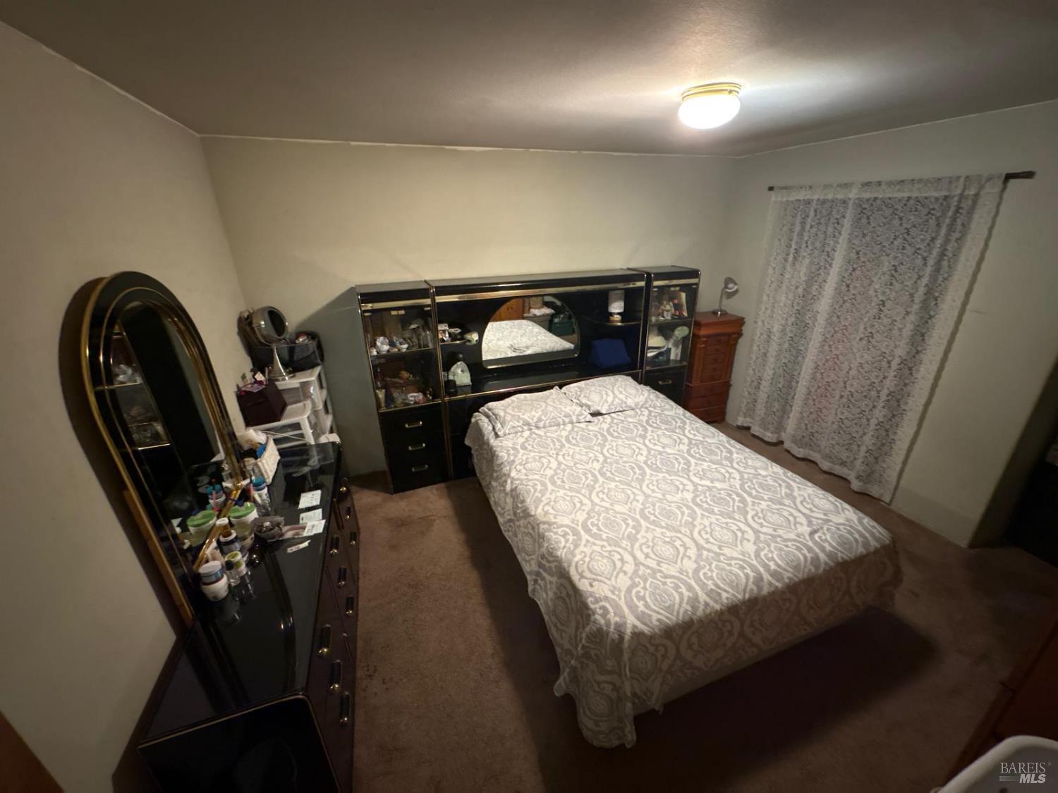 230 Shell Lane Willits, CA 95490 - Photo 32 of 32 a bed sitting in a room next to a window