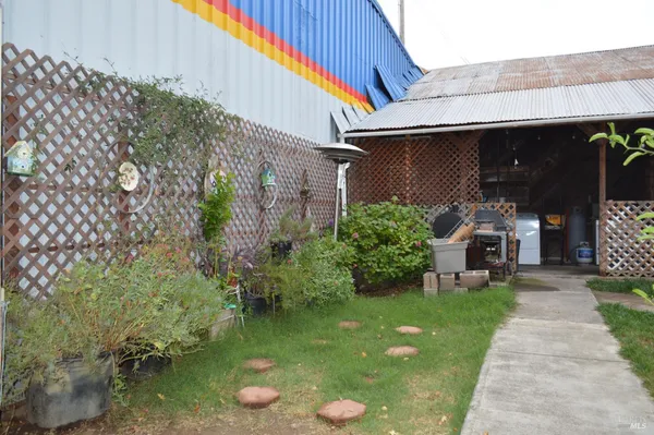 a view of a chair and table in backyard